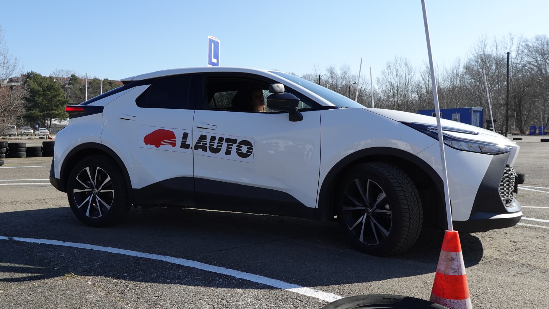 Student driving an OSK Lauto Toyota C-HR automatic on a manoeuvring area in Warsaw